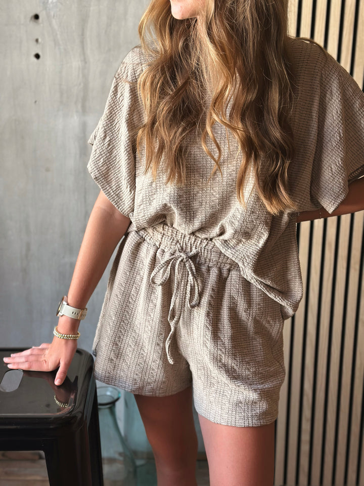 Front view of model wearing textured knit top & shorts set with elastic waist in the color taupe