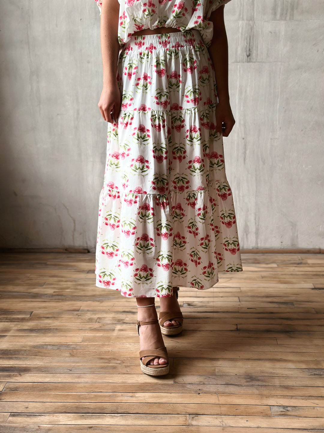 Front of floral print midi skirt features a high-rise, elasticated waistband