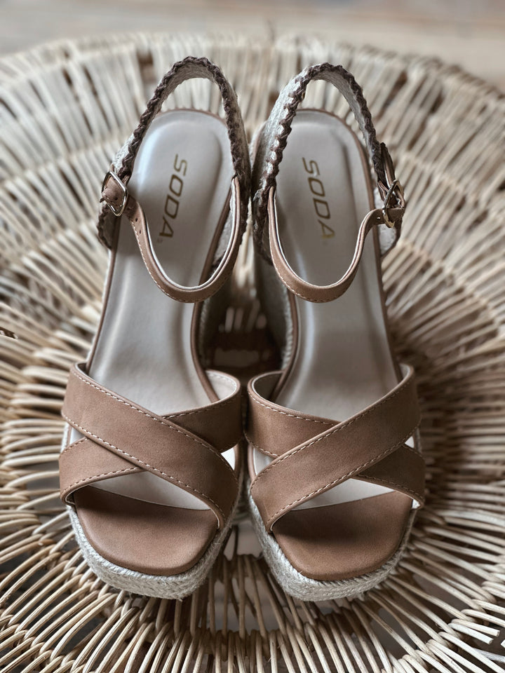 Front view of brown 4 inch wedge sandals, with a woven rapped midsole and an adjustable strap