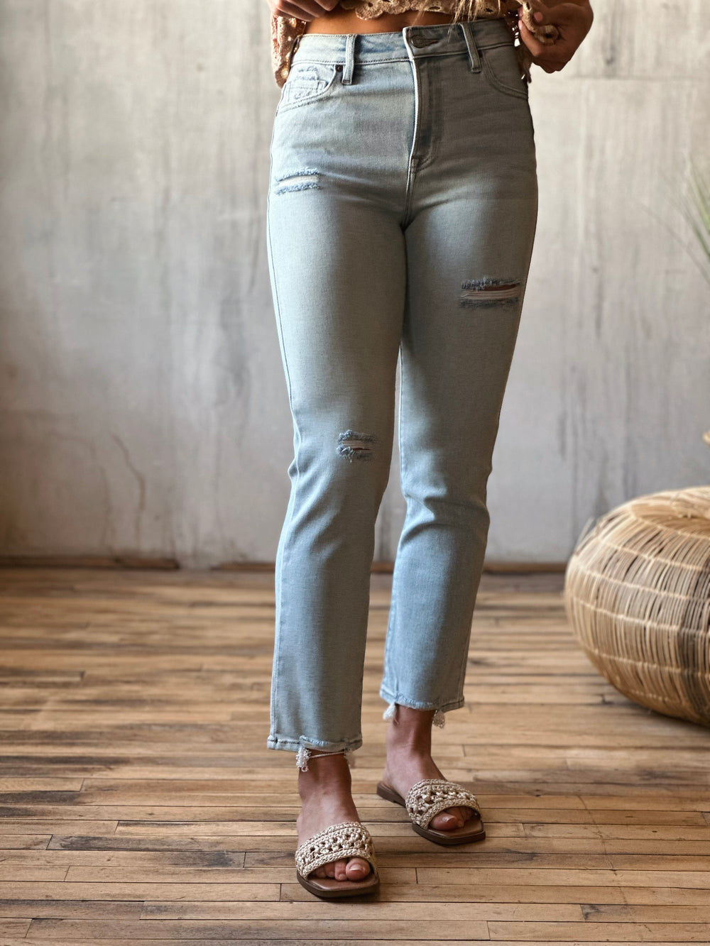 Front view of model wearing high-rise cigarette skinny jeans in a classic light blue wash.
