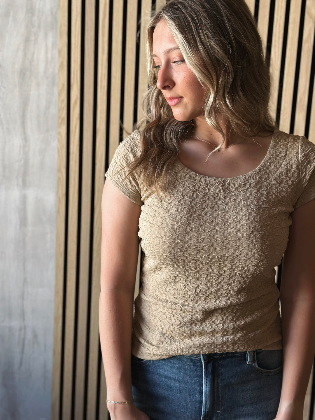 Front view of model wearing Popcorn Textured Knit Double Scoop Neckline Cap Sleeve Top in the color sand