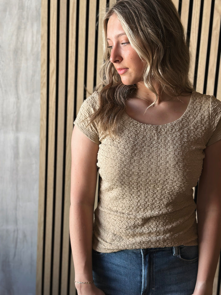 Front view of model wearing Popcorn Textured Knit Double Scoop Neckline Cap Sleeve Top in the color sand