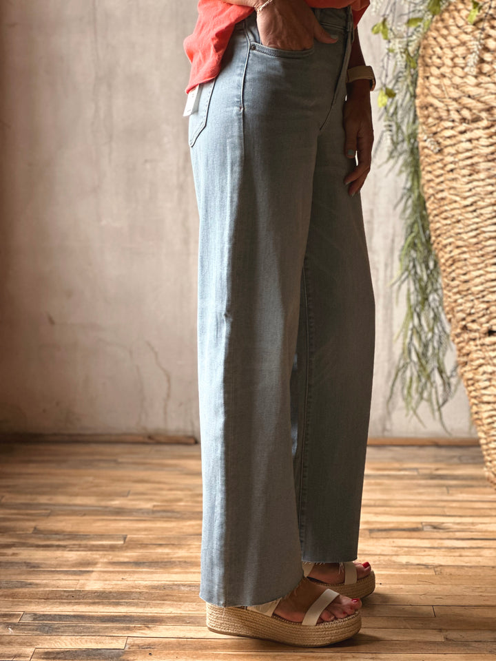 Side view of model wearing Mid-Rise Dad Fit Basic Jeans by Hidden, featured in a vintage wash