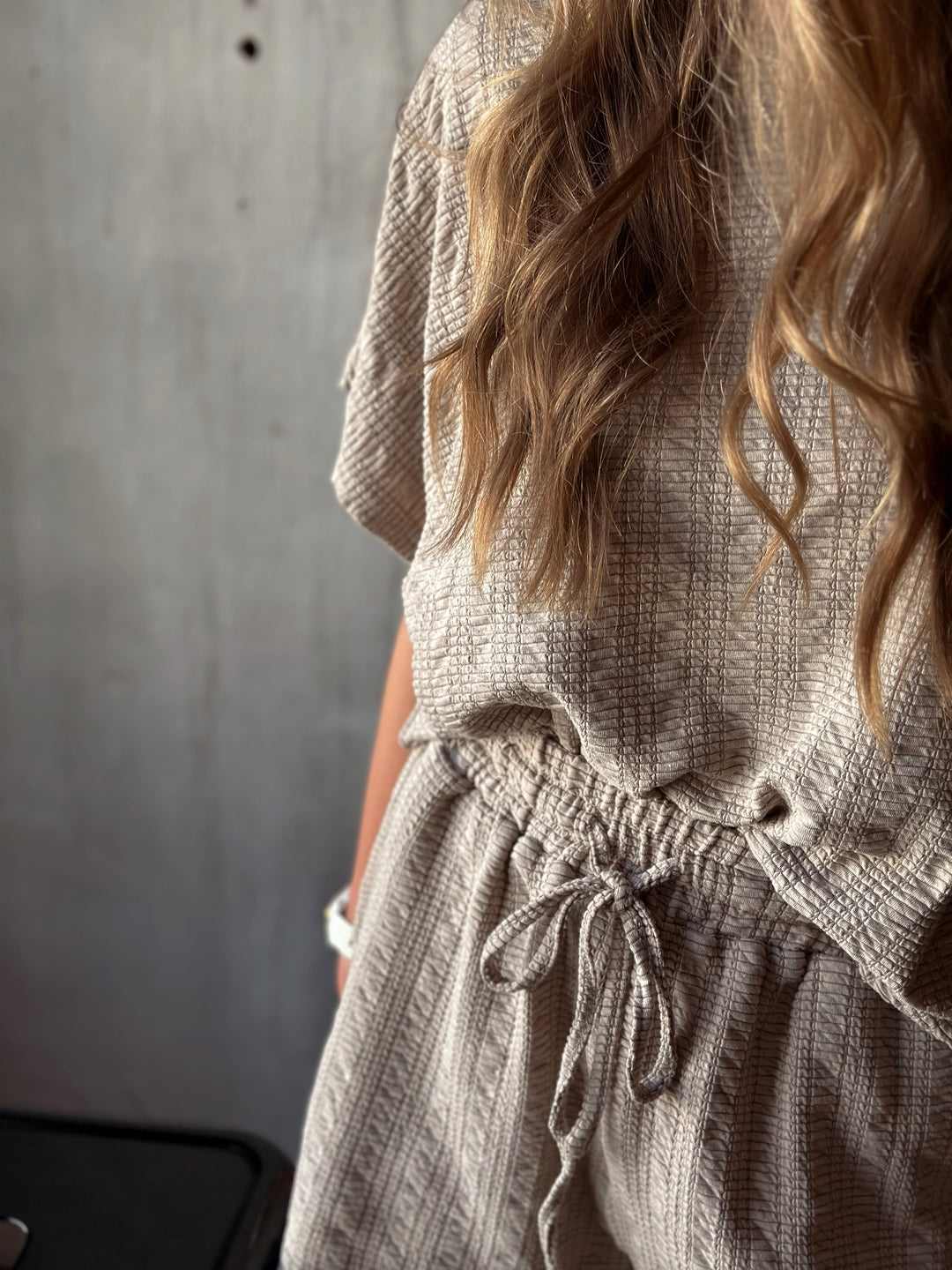 Front view of model wearing textured knit top & shorts set with elastic waist in the color taupe
