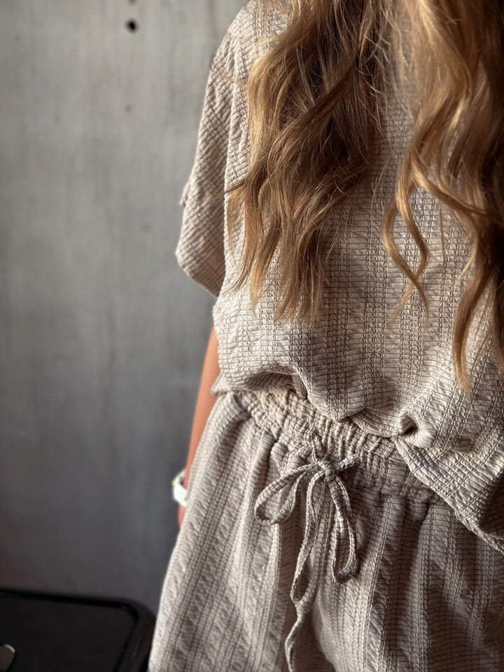 Front view of model wearing textured knit top & shorts set with elastic waist in the color taupe