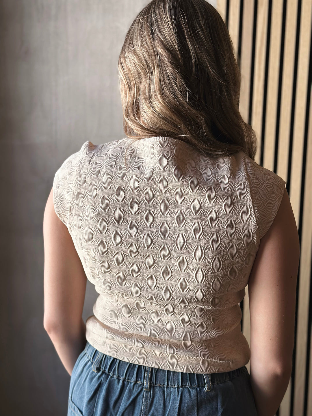 back view of model wearing a textured Knit Square Neck Cap Sleeve Tee in cream