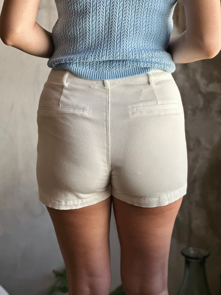 Back view of high waist white shorts, with lap pockets.