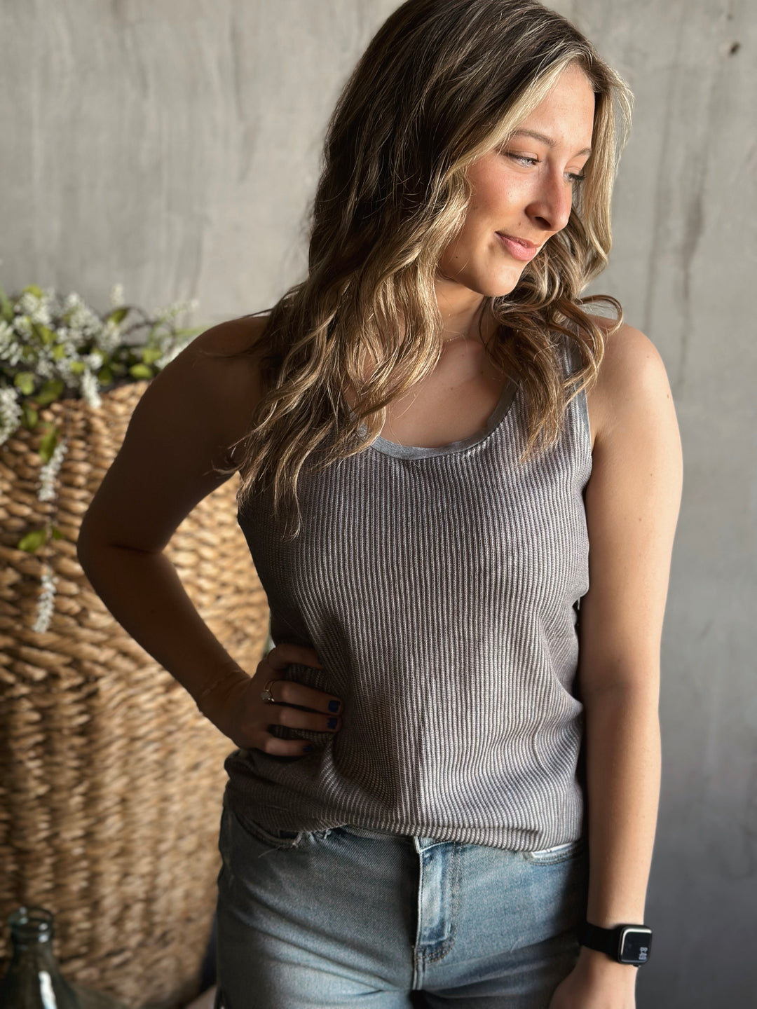 Front view of model wearing a ribbed textured knit tank top with a scoop neckline sleeveless design in the color gray