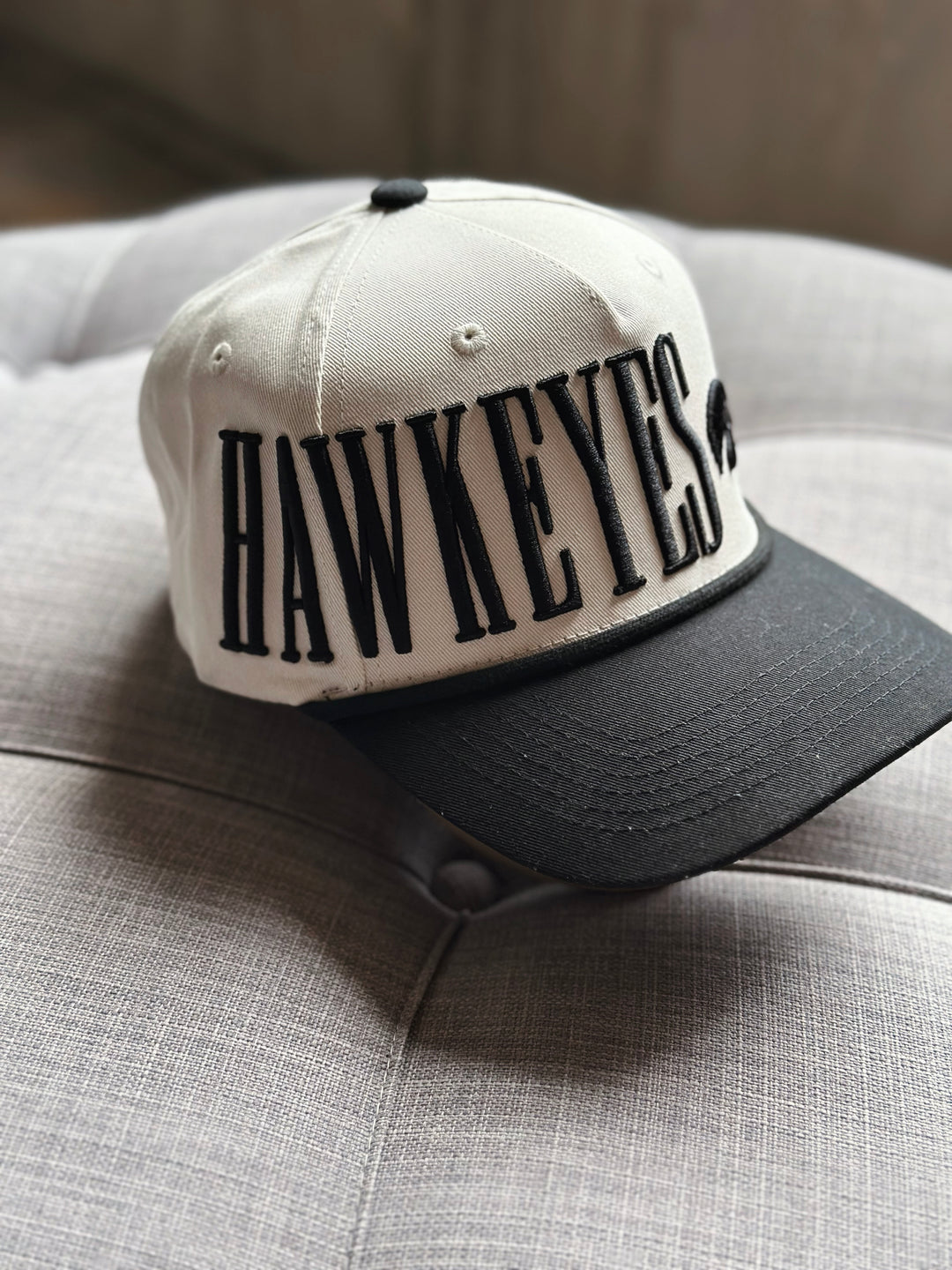 Cap with 'Hawkeyes' text on a gray surface