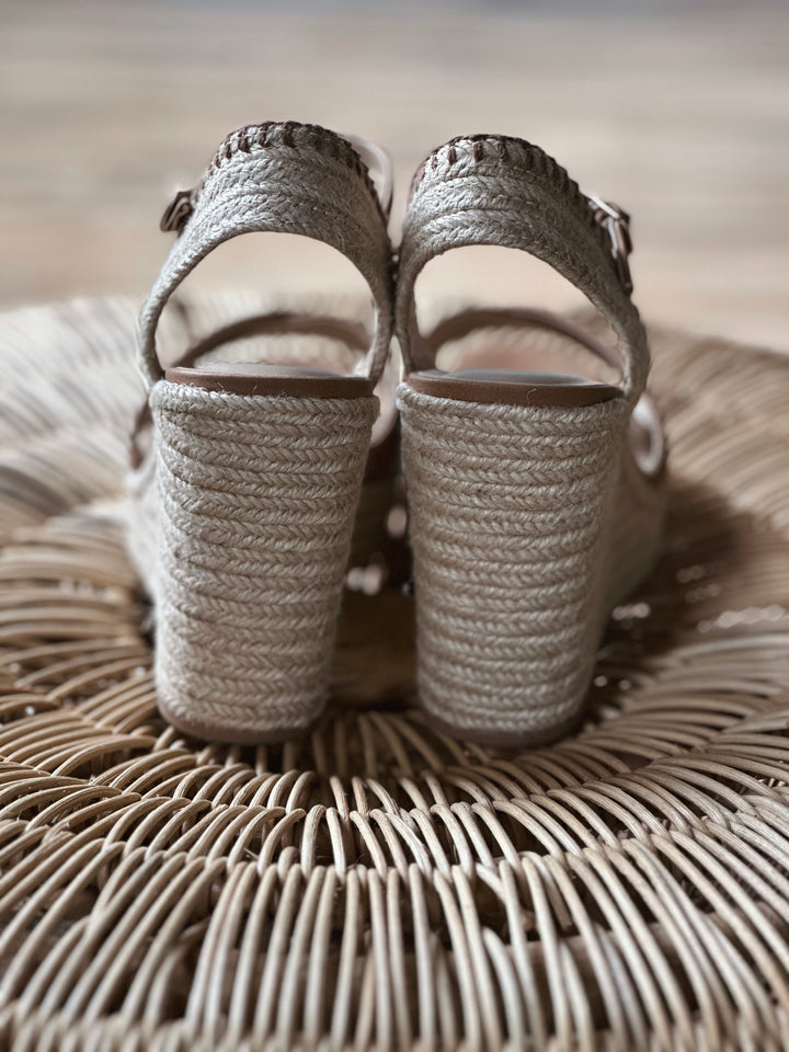 Back view of brown 4 inch wedge sandals, with a woven rapped midsole and an adjustable strap