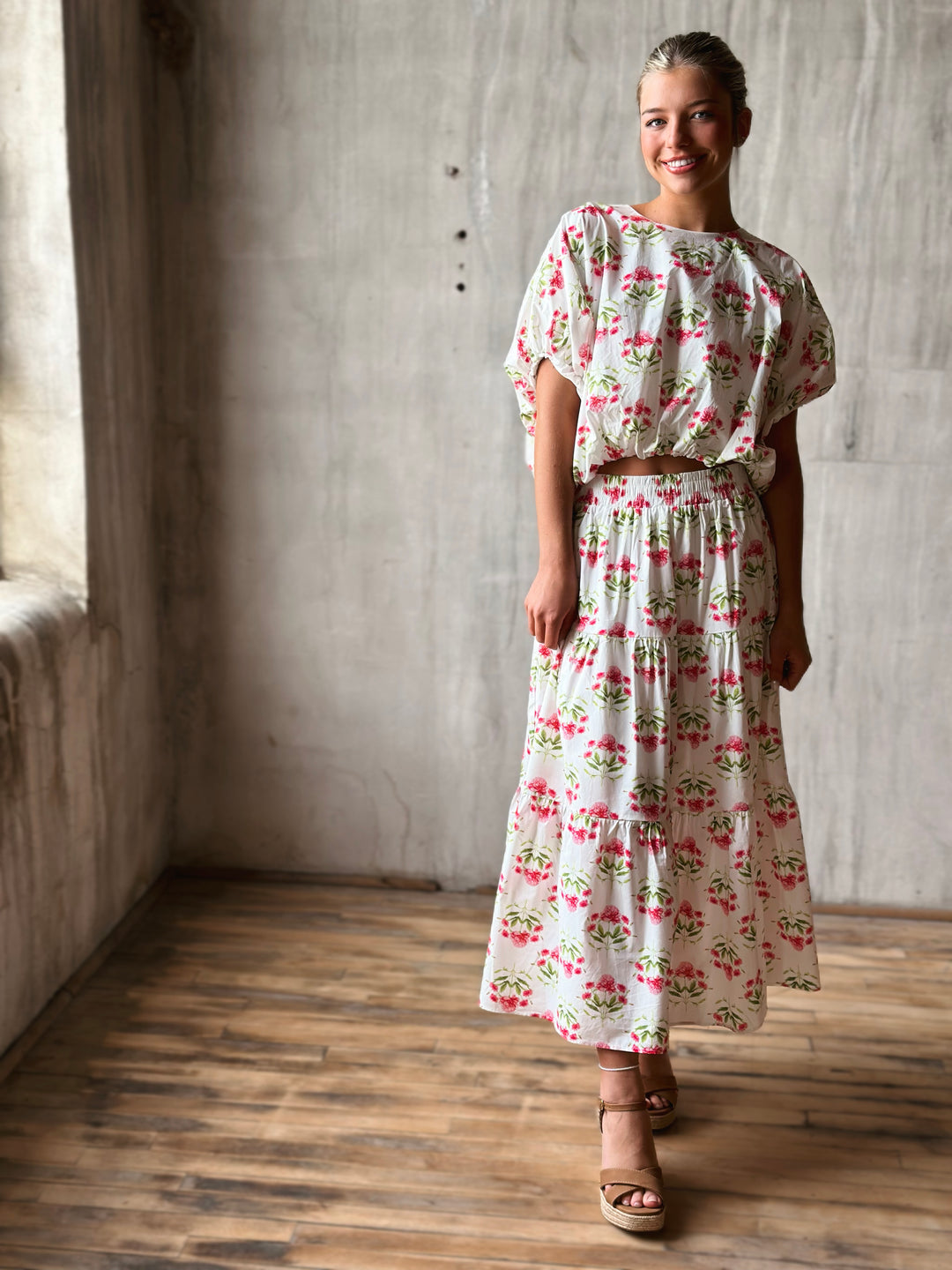 Front of floral print pullover top features a flattering bubble hem and a waist-length cut with matching skirt