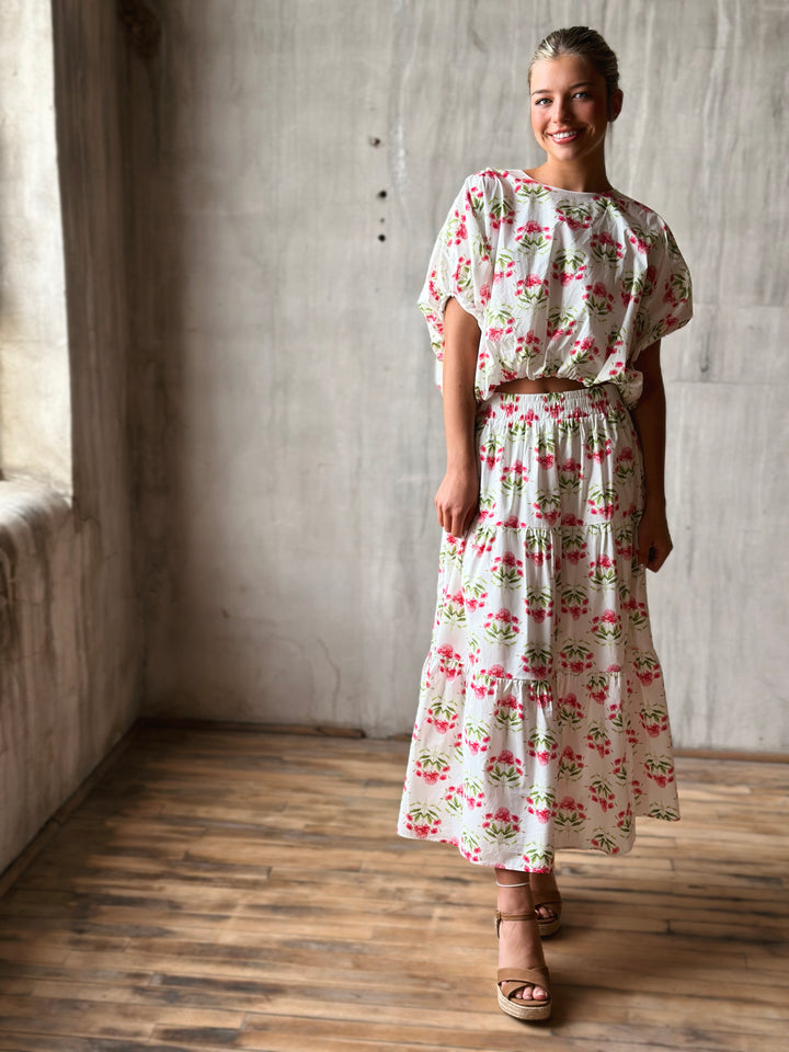 Front of floral print pullover top features a flattering bubble hem and a waist-length cut with matching skirt