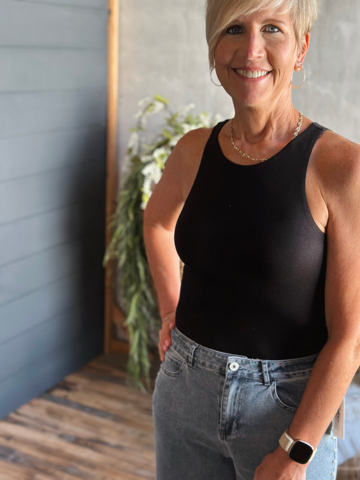 Front view of Black fitted bodysuit round neckline and tank straps