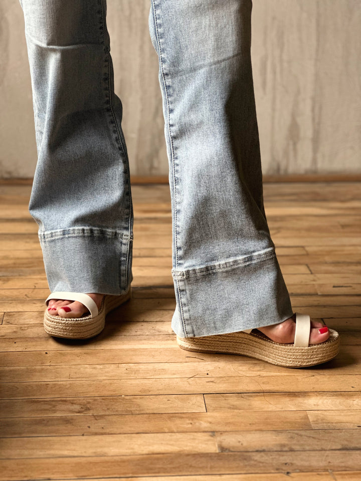 Front view of hemline of model wearing High-Rise Super Stretch Trouser Wide Leg Jeans
