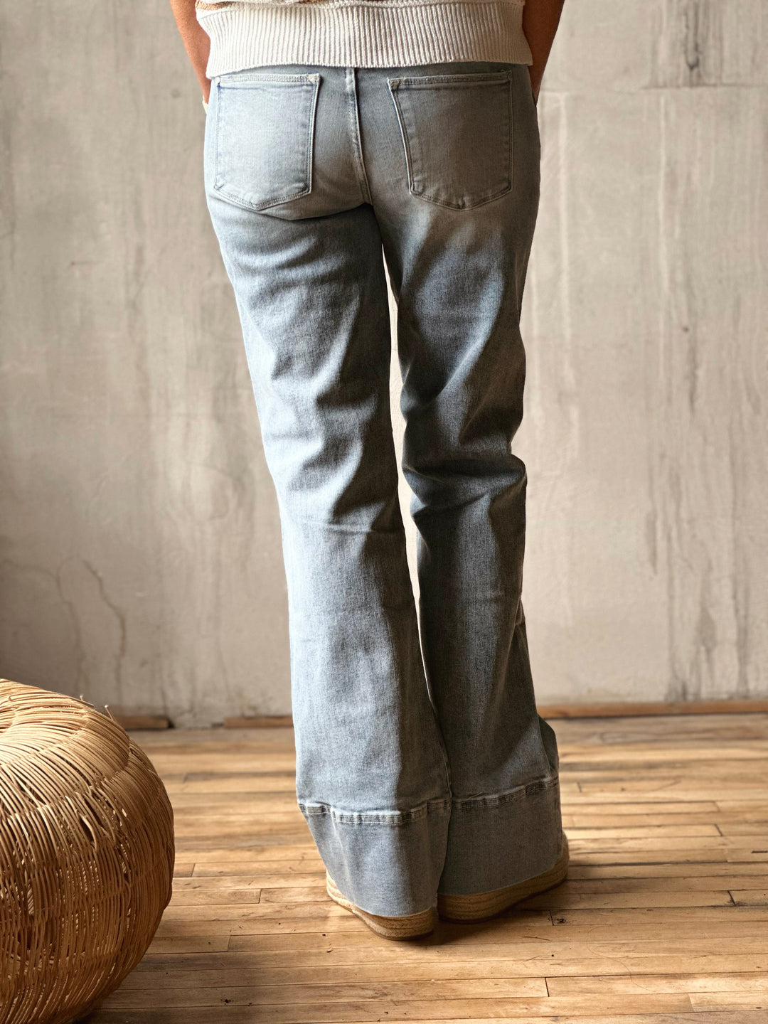 back  view of model wearing High-Rise Super Stretch Trouser Wide Leg Jeans
