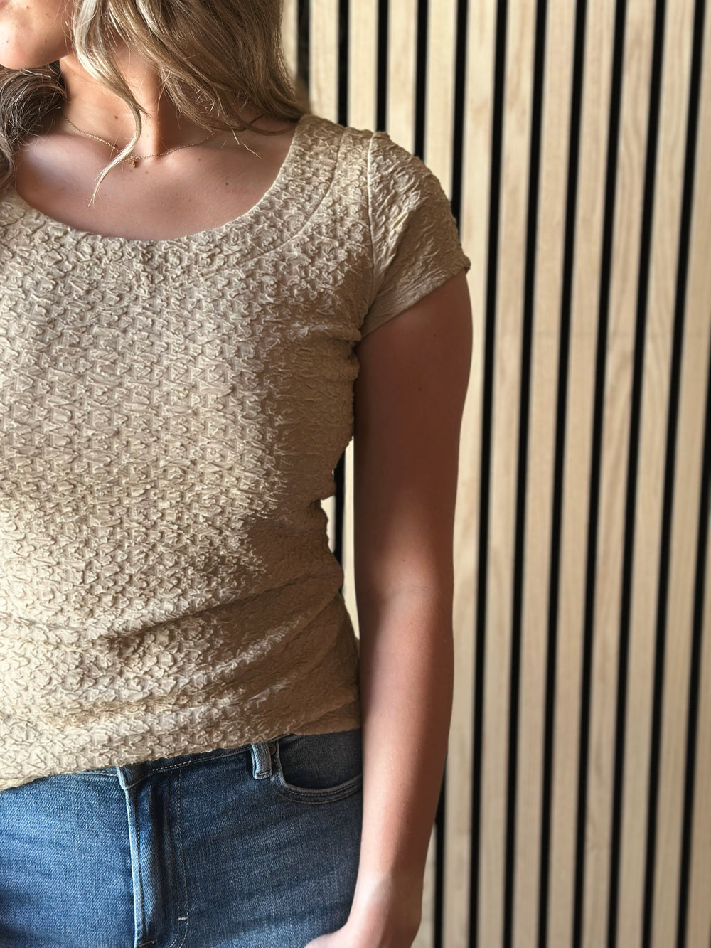 Front view of model wearing Popcorn Textured Knit Double Scoop Neckline Cap Sleeve Top in the color sand