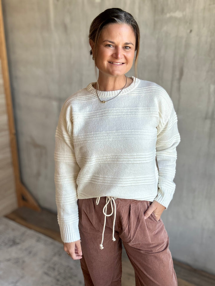 Cream textured crewneck sweater, front view