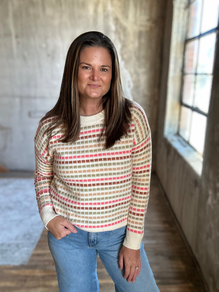 Cream multicolor striped knit sweater styled with jeans, front view