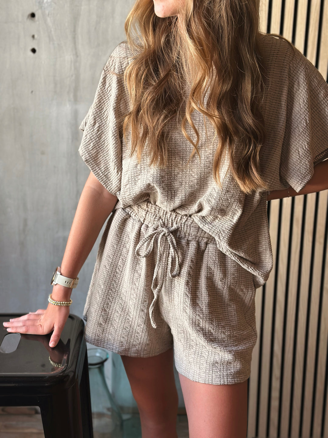 Front view of model wearing textured knit top & shorts set with elastic waist in the color taupe