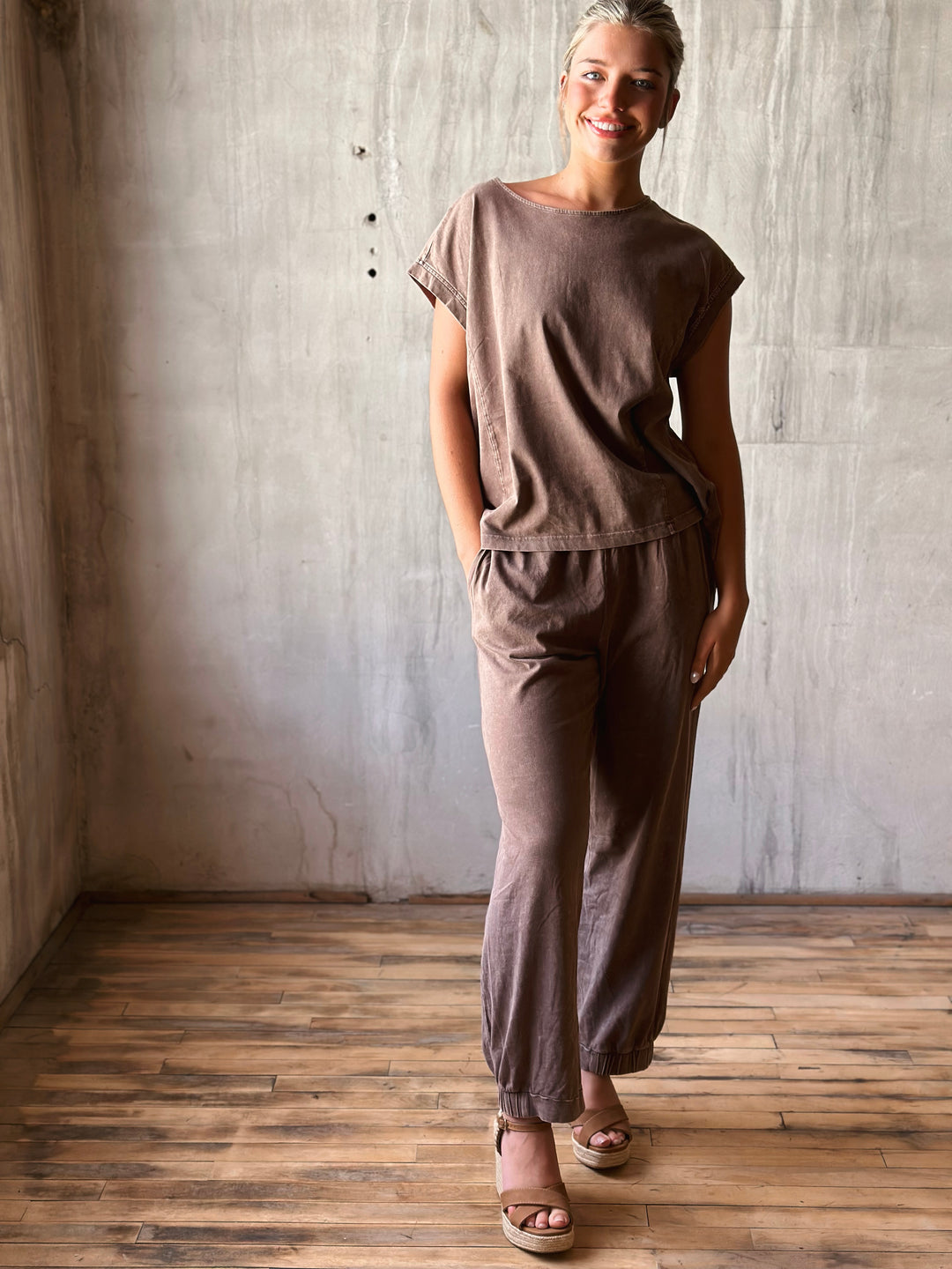 front view of relaxed, oversized fit top with dropped shoulders and a high-low hem. Matching pants mineral washed in mocha