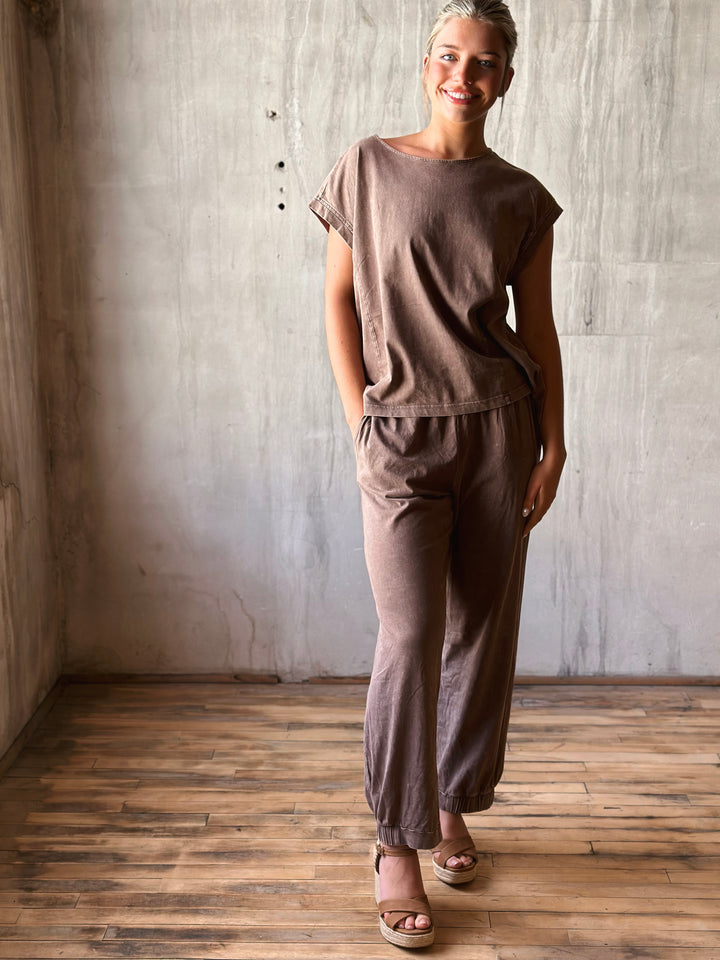 front view of relaxed, oversized fit top with dropped shoulders and a high-low hem. Matching pants mineral washed in mocha