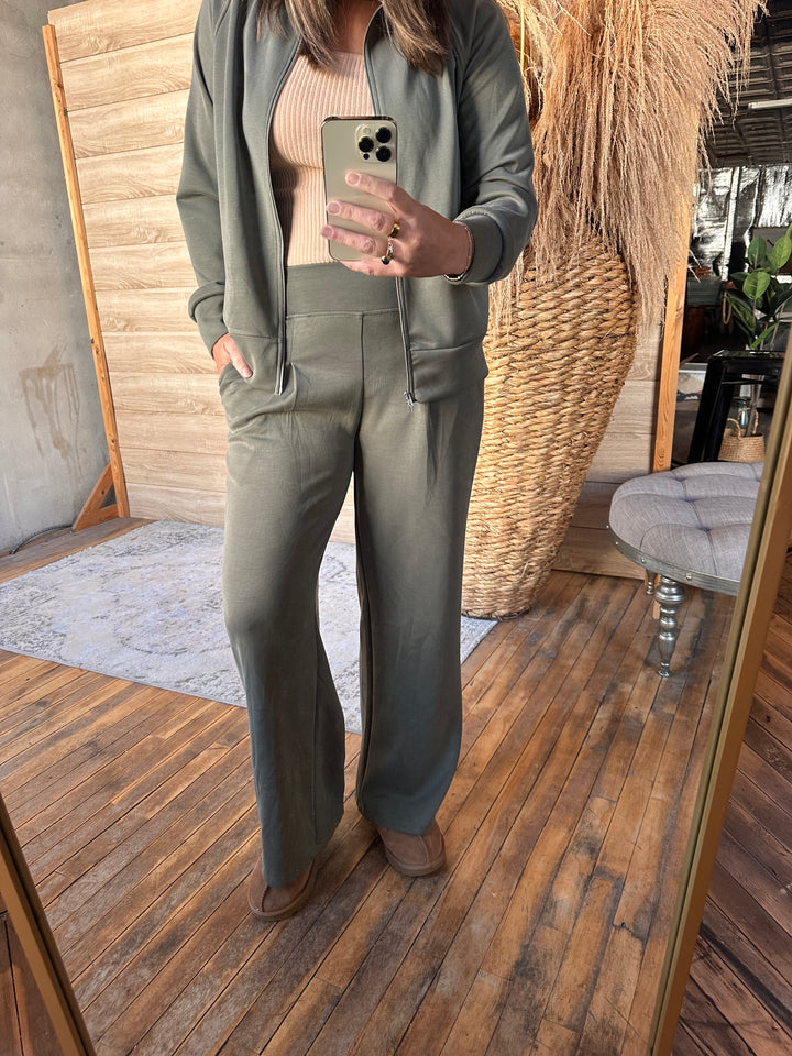 Mirror selfie in olive green wide-leg pants with a matching jacket