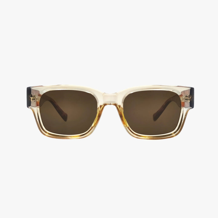 Sunglasses with a gold frame and brown lenses on a white background