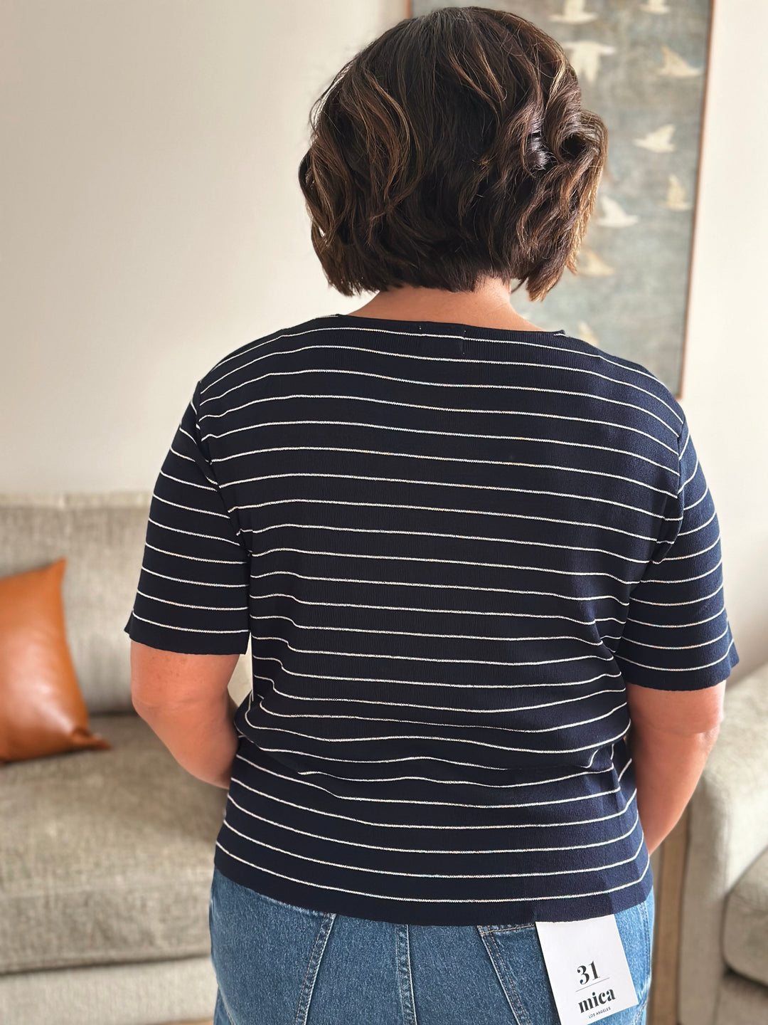 Person wearing striped shirt in a casual setting.
