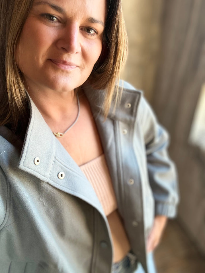 Detail of the collar and snaps on a slate blue jacket