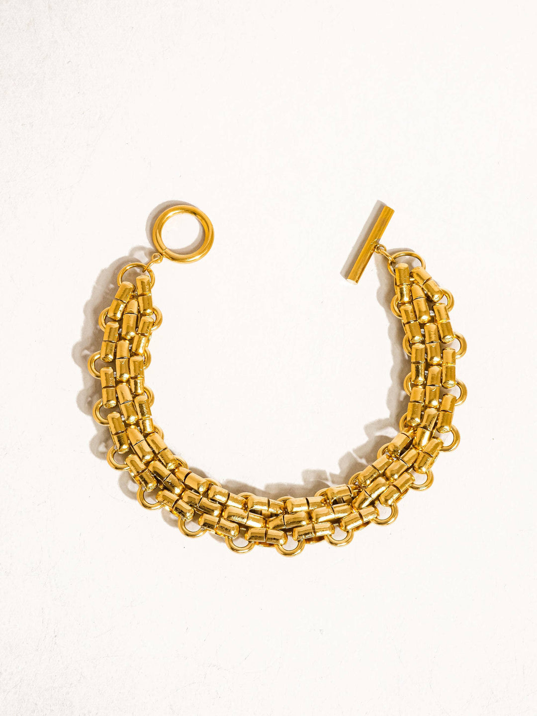 Gold chain bracelet on a white background