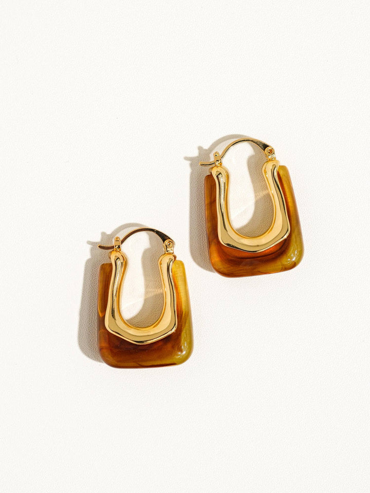 Gold hoop earrings on a white background