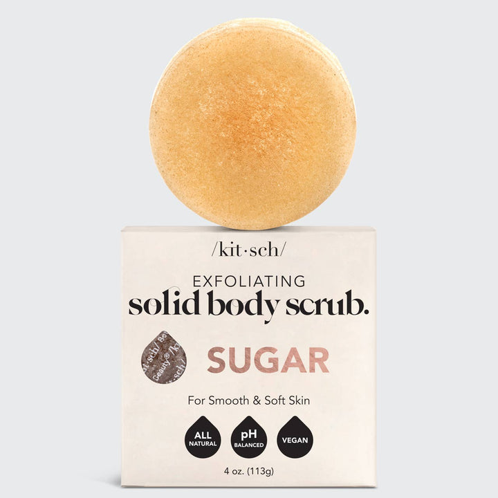Exfoliating solid body scrub with packaging on a light gray background