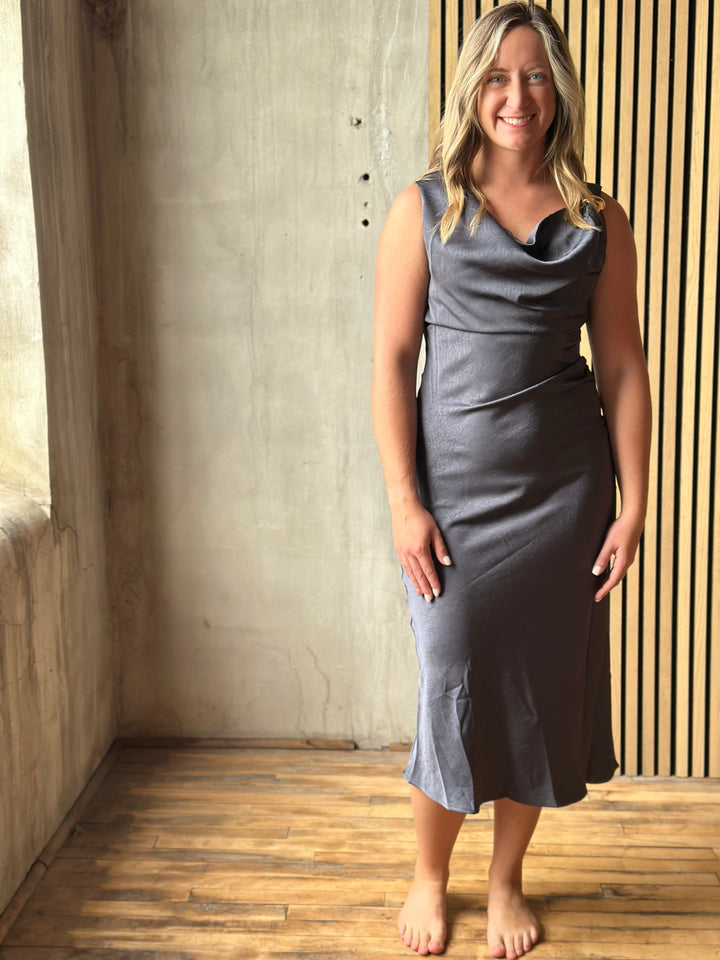 Woman in a slate gray satin cowl-neck midi dress, full view