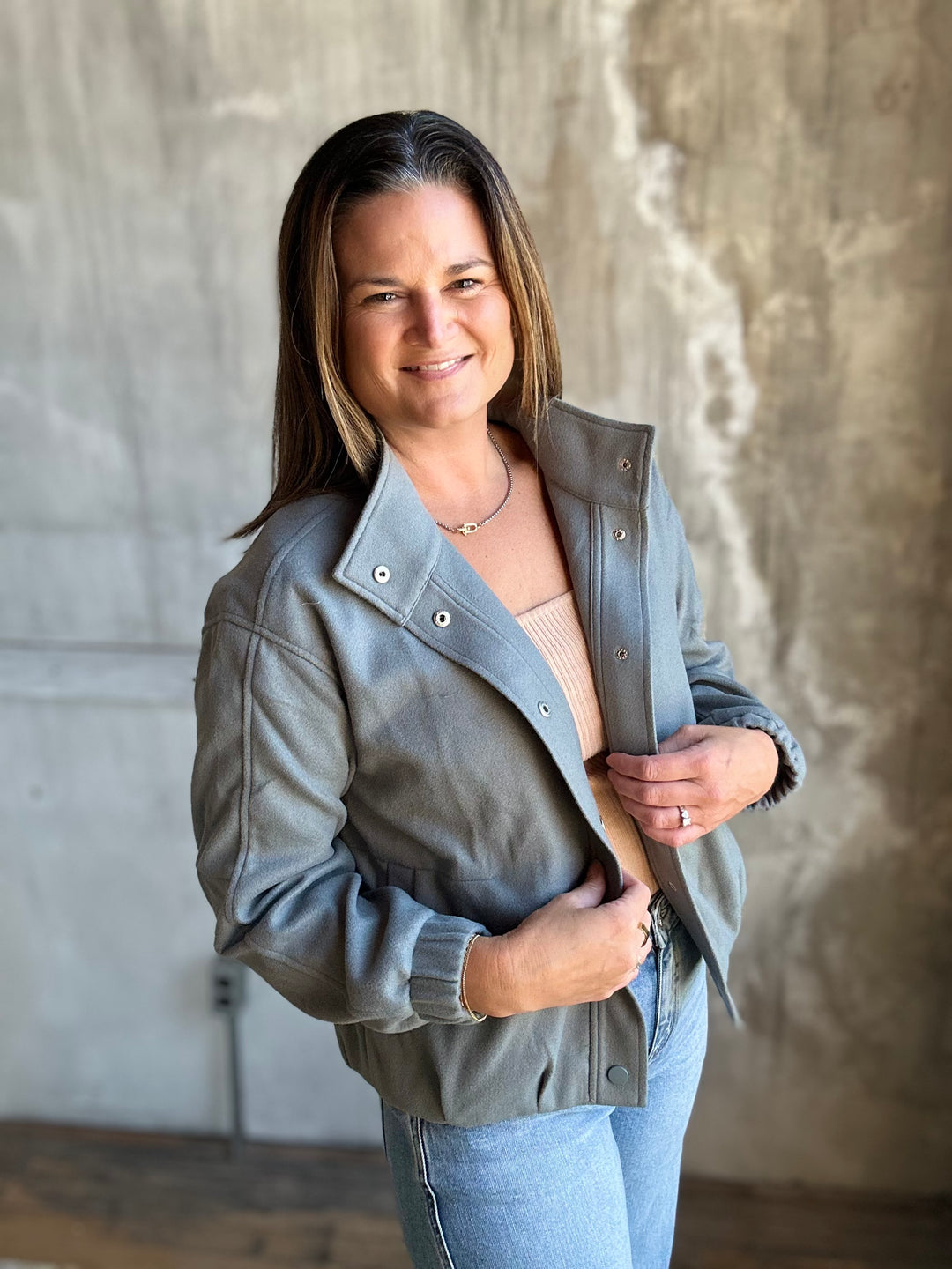 Slate blue snap-front jacket worn open with a stand collar, angled view