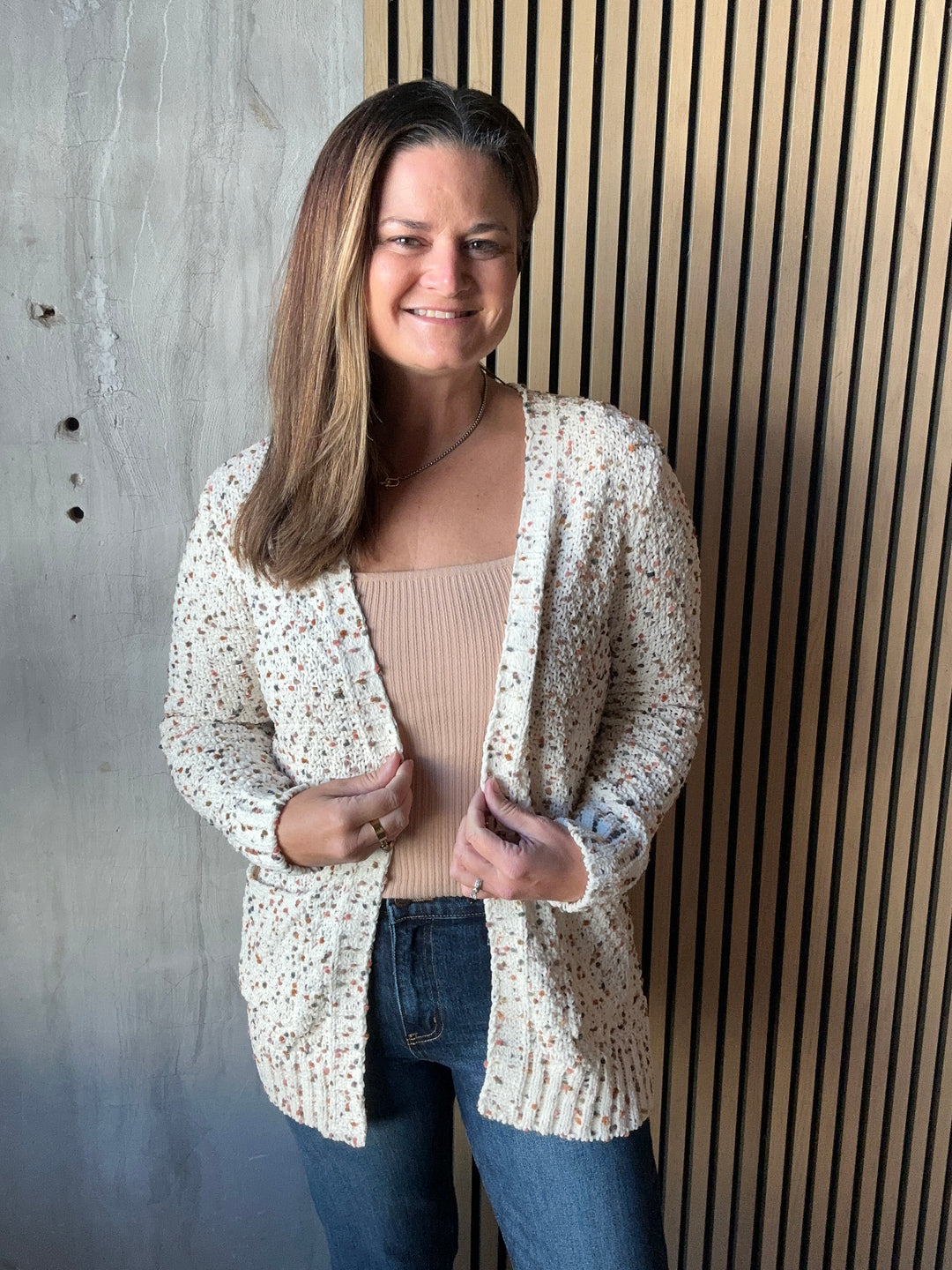 Cream speckled-knit cardigan worn open, front view