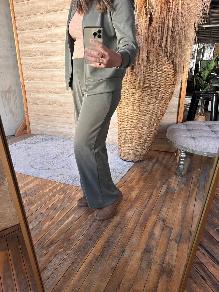 Olive green wide-leg pants shown in a full-length mirror photo