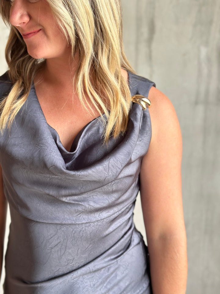 Detail of the draped cowl neckline on a slate gray satin dress