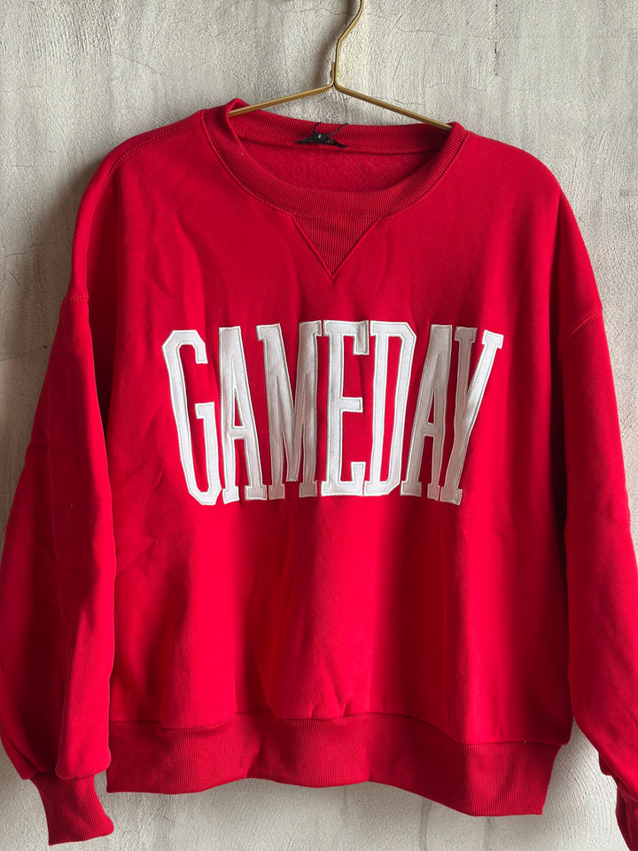 A red crewneck sweatshirt with &