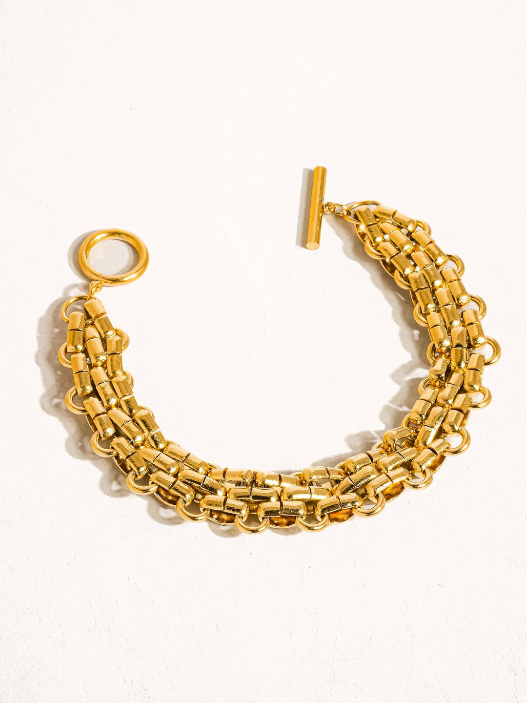 Gold chain bracelet on a white background