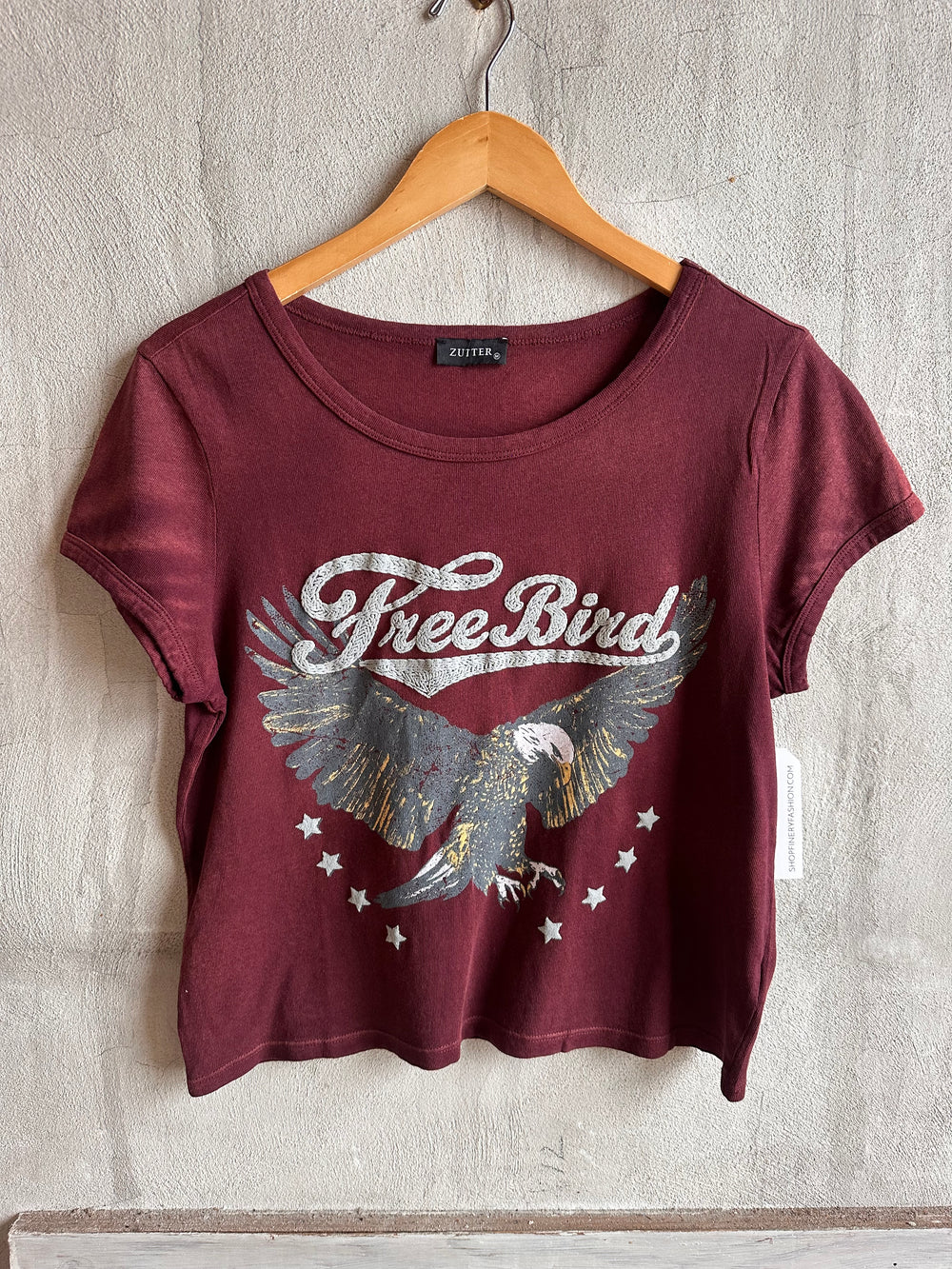 Burgundy Free Bird eagle graphic tee on a hanger