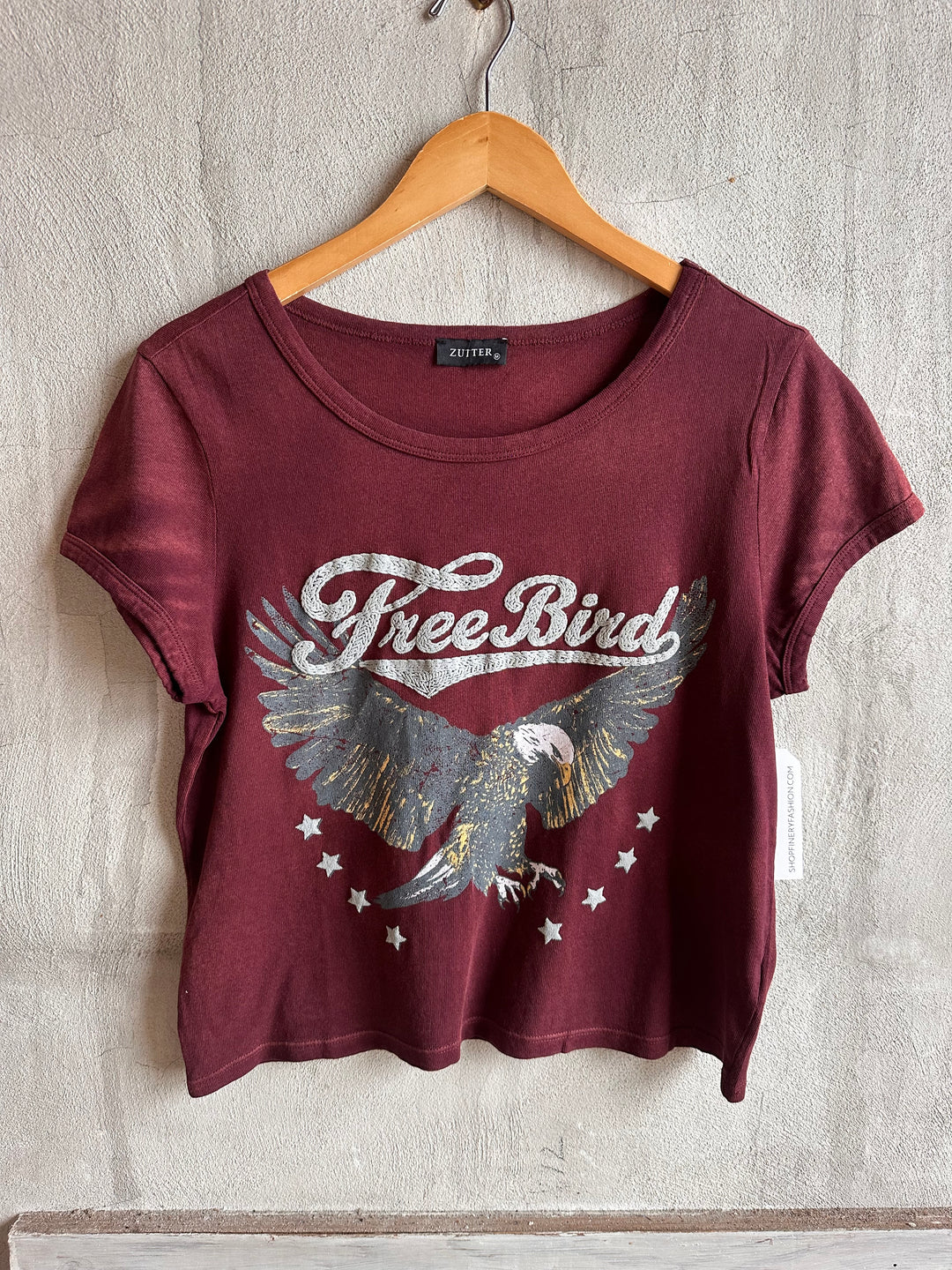 Burgundy Free Bird eagle graphic tee on a hanger
