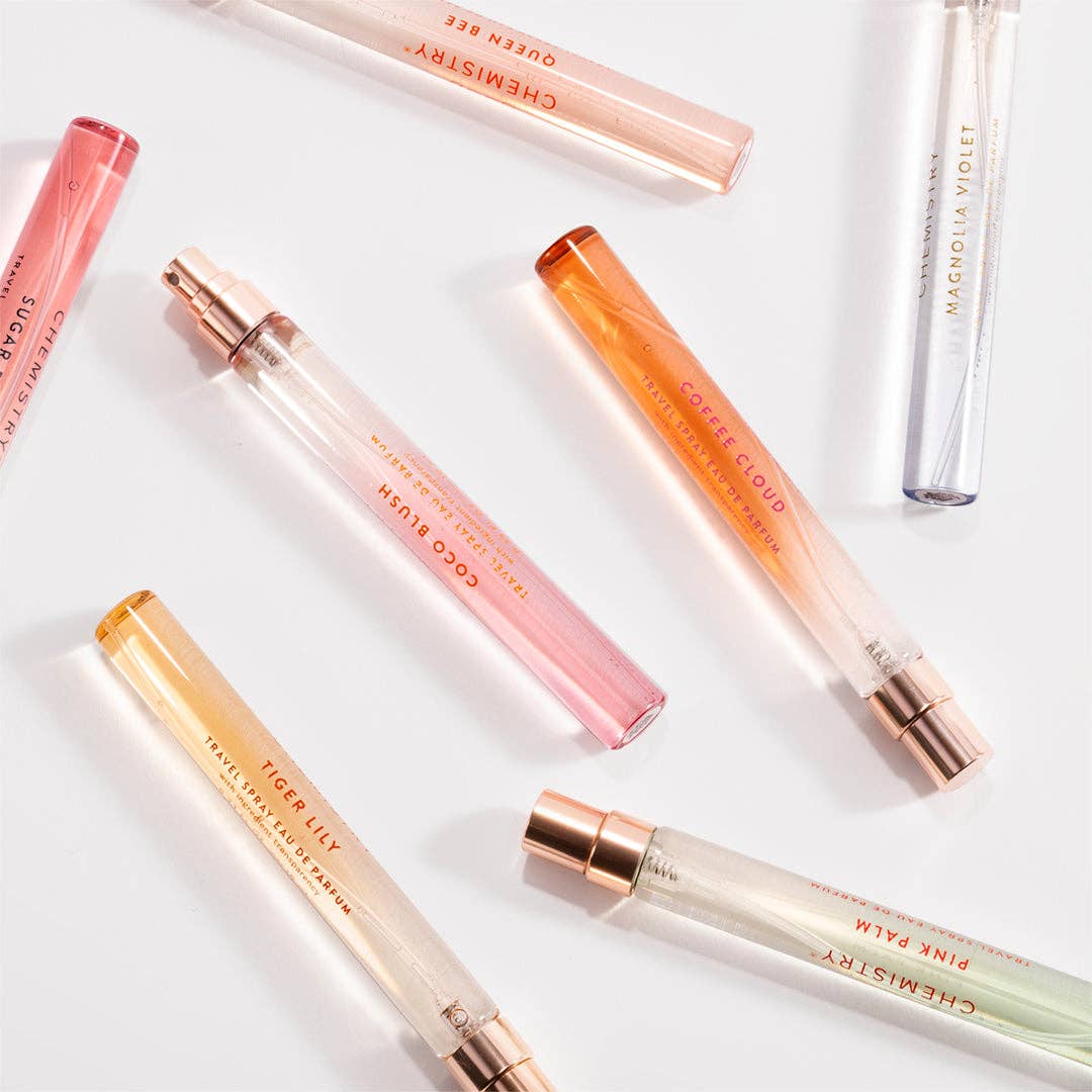 Set of small perfume bottles with visible names on a light background