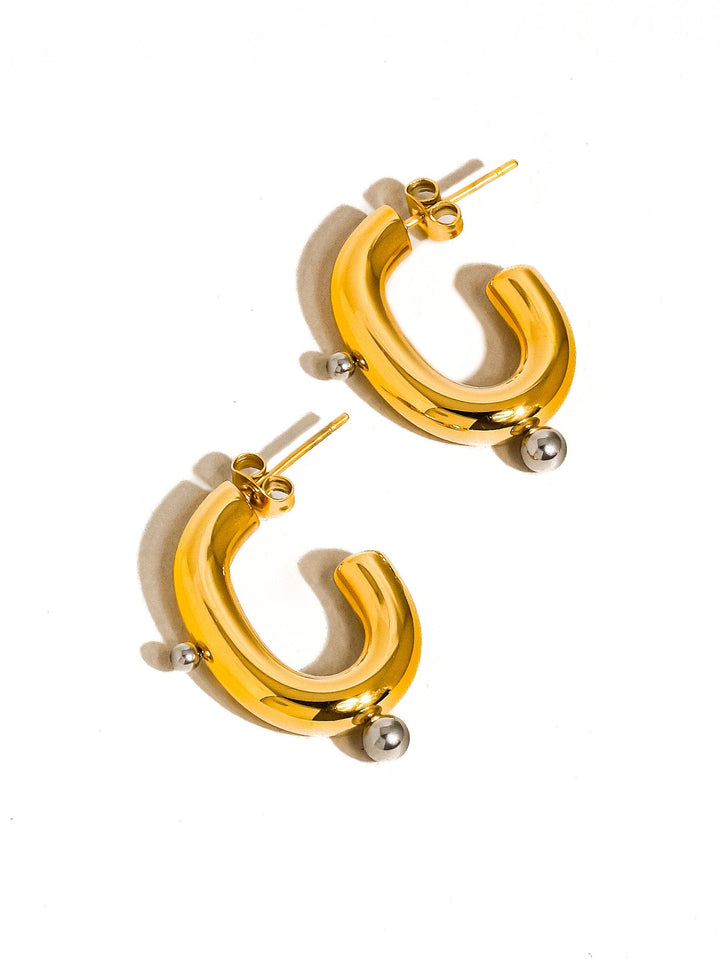 Gold hoop earrings on a white background
