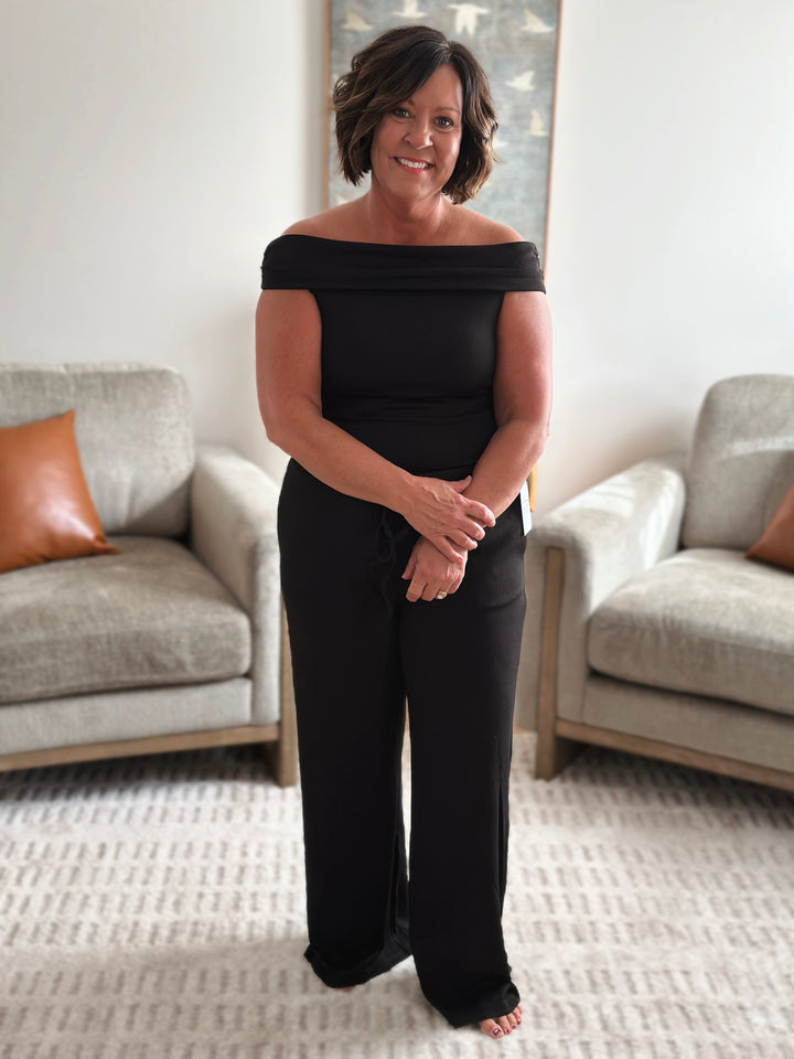 Woman in a black outfit looking forward