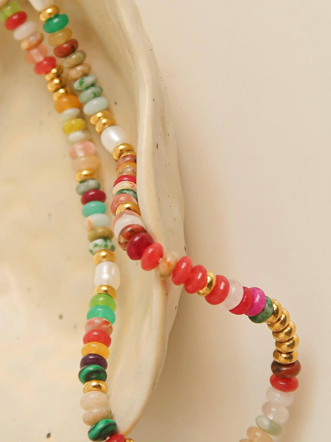 Colorful beaded bracelet on a beige shell background