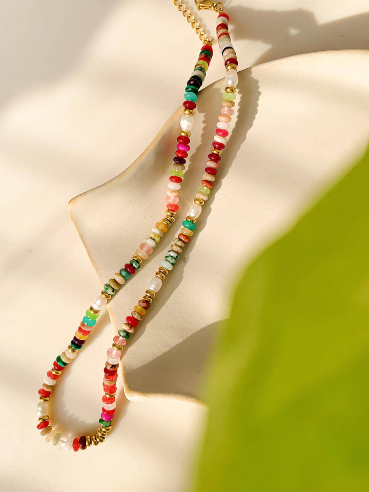 Colorful beaded necklace on a beige background