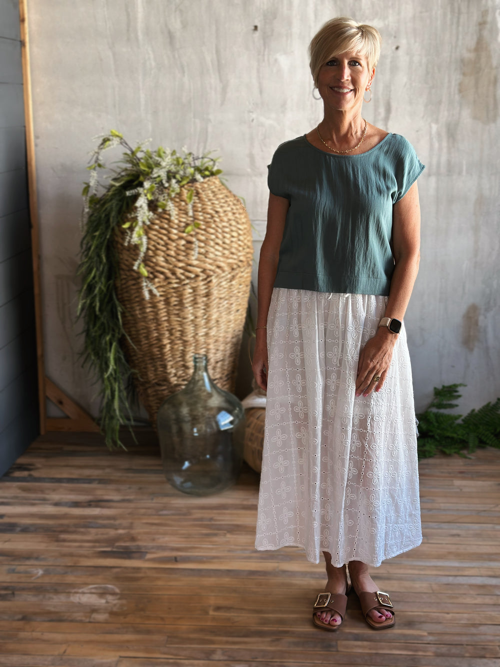 front view white eyelet midi skirt,  Featuring a high elastic waist with a front tie drawstring, delicate ruffle trim, and a classic eyelet pattern.