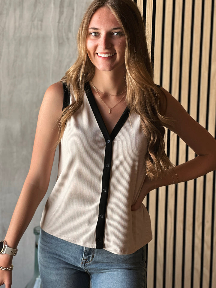 Front view of what model wearing sleeveless V-neck top with functional front button down and ribbed knit fabric