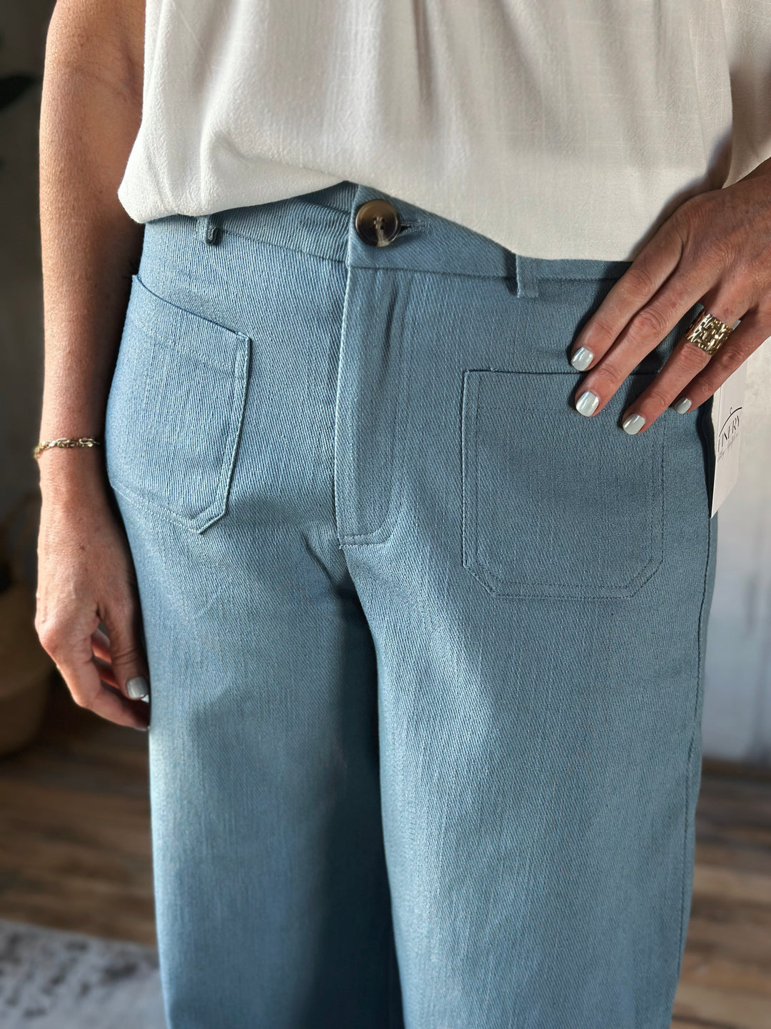 Light blue pants worn by a person with a neutral background