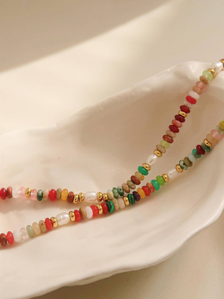 Beaded necklace with multicolored beads on a white surface